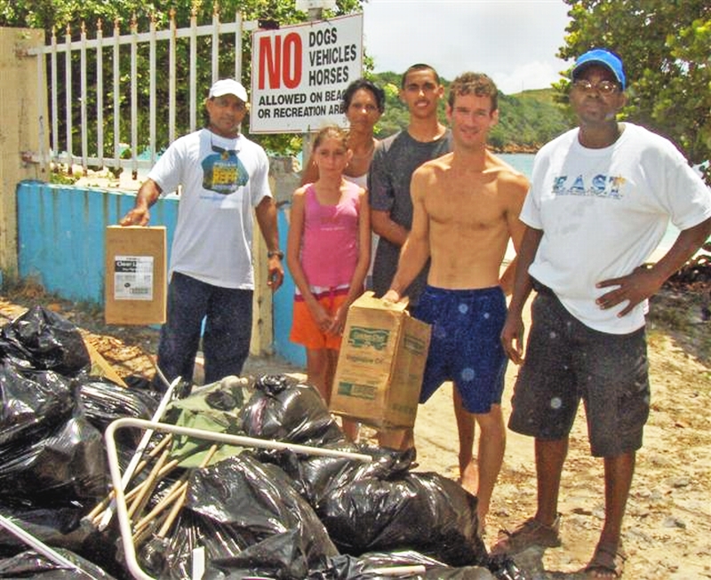 Volunteers with the trash they collected (from left): Steve Kalpee, Analis Petersen, Chrys Petersen, Sean LaPlace, Jason Budsan and Dalma Simon. Kalpee and Budsan hold oil containers found in a tree.