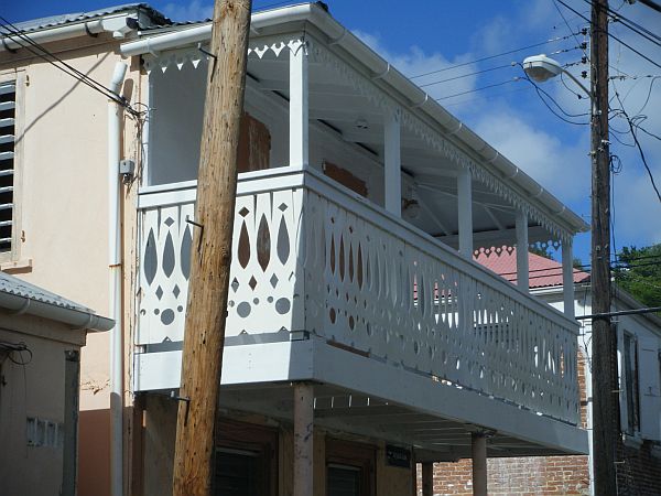 One of the group's projects was to renovate the balcony of this building, adding custom-made gingerbread railings and trim.