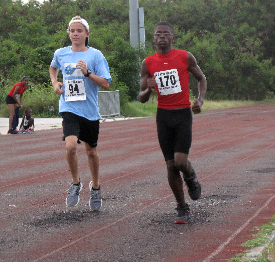 In one of the exciting runs, Mathew Mays (120) St. Croix Dolphins/V.I.Swimming Federation and Youth; Olympics qualifier sprint to the finish with Dalton Baptiste St. Croix Track Club/V.I. Track and Field Federation