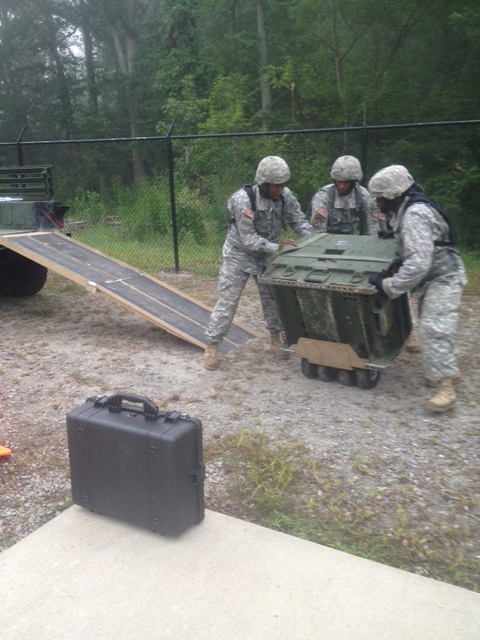 (From left to right) Sgt. Cosme Harrison, Spc. Jahbari Burton, Sgt. Emile Proctor and Sgt. Roane Dowe offload a 3K generator that will power their water systems during the ROWPU Rodeo at Ft. Story, Va. (VING Photo)