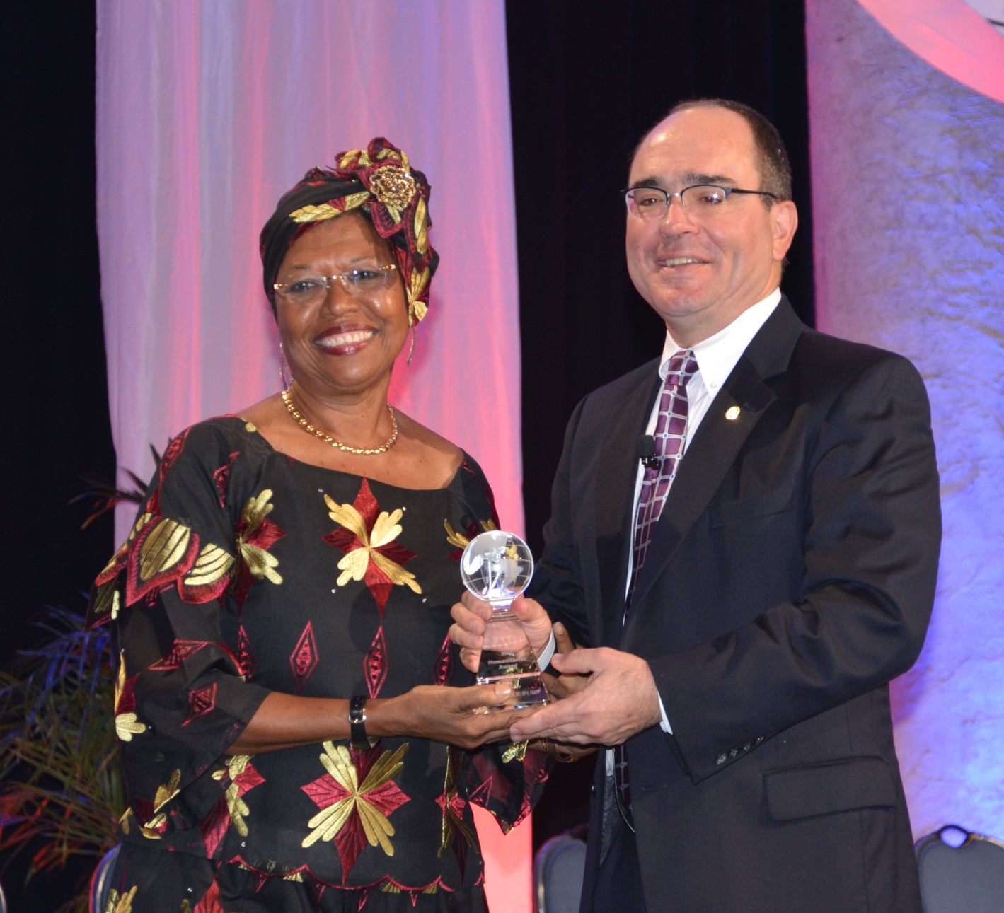 Dr. Cora L.E Christian receiving the 2013 American Academy of Family Physicians (AAFP) Humanitarian Award from the president of AAFP at its Congress of Delegates.