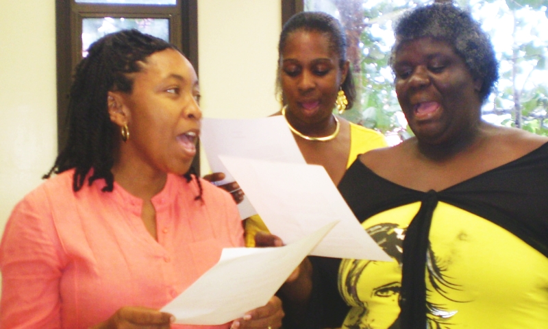 From left: Lorraine Cadet, Susan Thompson and Franceline Bacchus sing "One Love" by Bob Marley in the lyric-writing workshop.