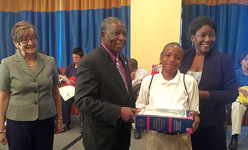 (from left) DOE Deputy Commissioner Dr. Sarah Mahurt, Lieutenant Governor Gregory R. Francis and DOE Commissioner Dr. LaVerne Terry congratulate 2012 Territorial Spelling Bee champ Yad Bass after his win Friday