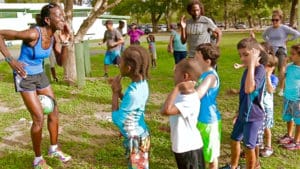 Therese Hodge, president of the St. Thomas Association of Roadrunners, gets young runners prepared Saturday.