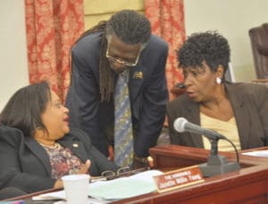 Sens. Janette Millin Young, left, Positive Nelson and Alicia 'Chucky' Hansen confer during Tuesday's session. (Photo by Barry Leerdam, provided by the V.I. Legislature)