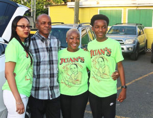 Music man and Carnival Village honoree Juan Harrigan, second from the left, celebrates with his family Friday night.
