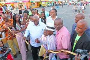 Gov. Kenneth Mapp, Lieutenant Governor Osbert Potter, Village honoree Juan Harrigan and members of this year’s Carnival court officially open the Carnival Village Friday night.