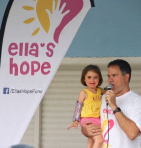 Shaine Gaspard hold his daughter Ella at the first annual 5K walk/run to raise funds to cure Rett syndrome. 