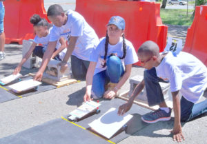 Students prepare their cars at the starting line.