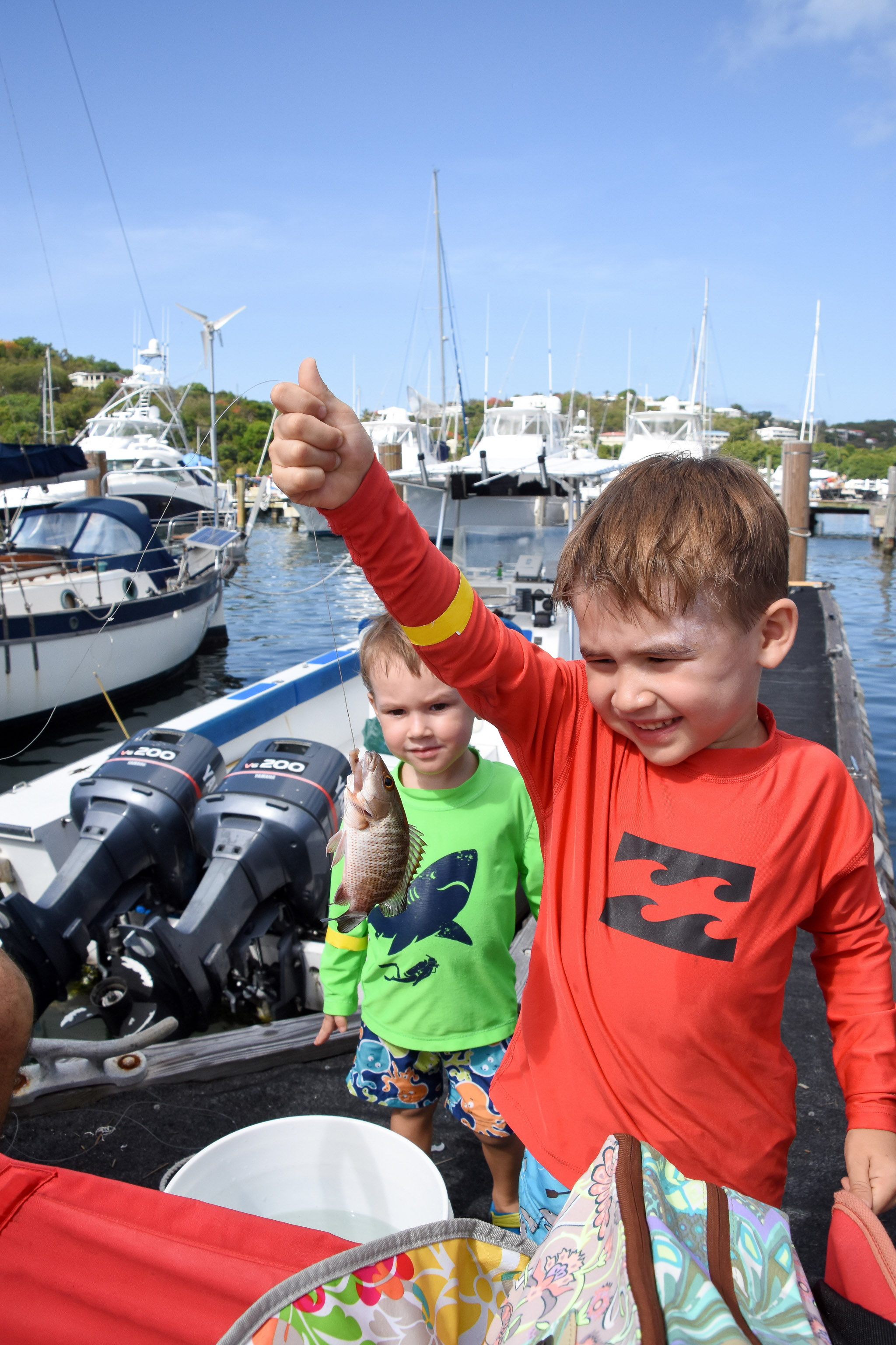 Four year Eli Hume shows off his catch while 2-year-old brother, Wyatt, looks on