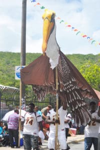 Ivanna Eudora Kean High School athletes carry a large-scale pelican puppet for the Governor’s Summer Reading Challenge.