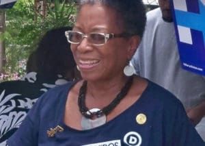 Donna Christensen, seen here at a 2016 Democratic rally, is working to pull party factions together.