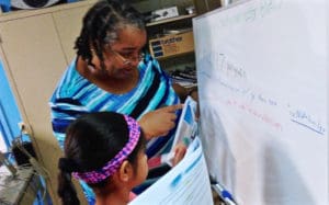 Anita Davis works with a student at 'Code Like A Girl' camp Wednesday. (Photo provided by V.I. Next Generation Network)