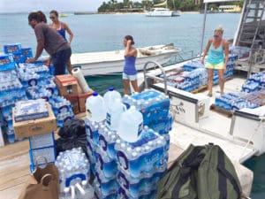 Volunteers load supplies aboard Caribbean Sea Adventures vessel on Sept. 10, between hurricanes. FEMA reported it has 14 million liters of water position in case a storm strikes the territory this season. (Photo by Sarah Ridgway)