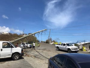 Drivers work their way around a downed pole and power lines on the road to Anna's Retreat. (James Gardner photo)