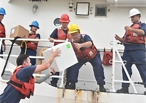 Crew from Coast Guard Cutter Winslow Greisser transfer critical prescription medication for delivery to St. Croix Saturday. (Coast Guard photo)