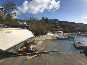 Beached and wrecked boats line Cruz Bay's waterfront.