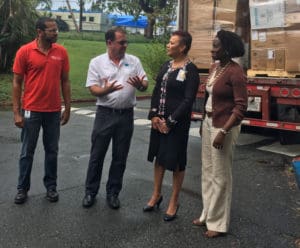 From left, Troy de Chabert-Schuster, Omar Haedo, Wanda Ruben, Deanna James, discuss the shipment of medical supplies the Juan F. Luis Hospital received Tuesday.