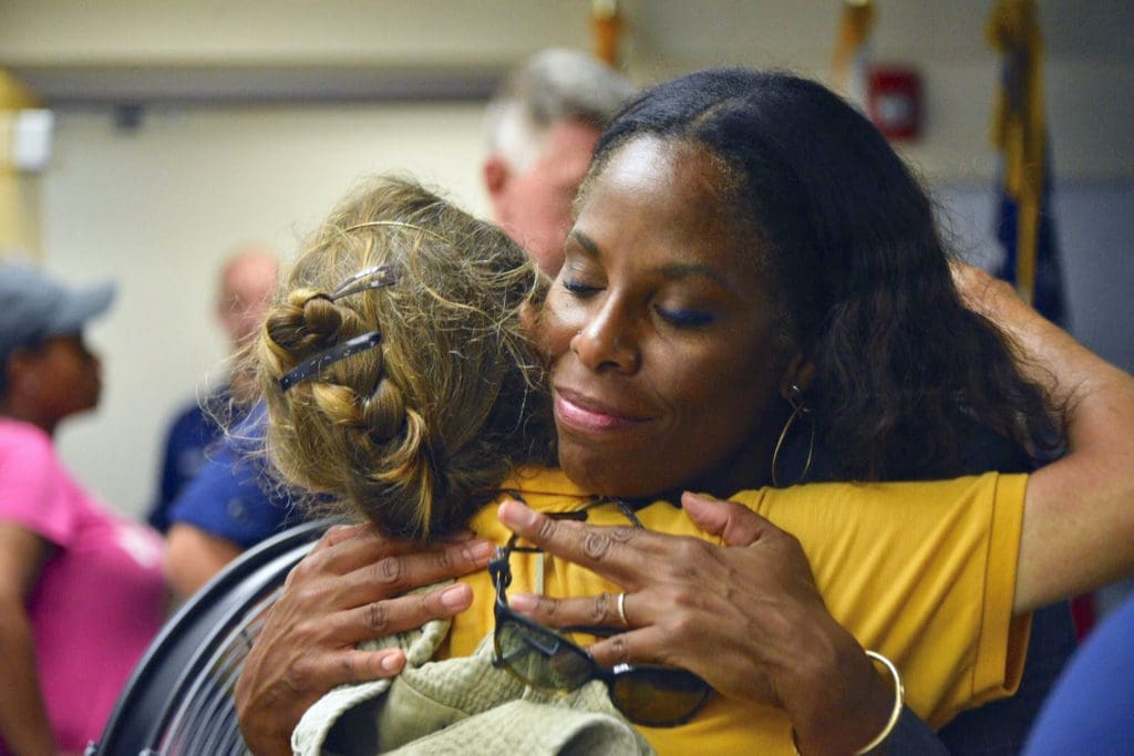 Delegate to Congress Stacey Plaskett embraces a Virgin Islander after the territory was hit by two category five hurricanes. (Photo from Plaskett's official website)