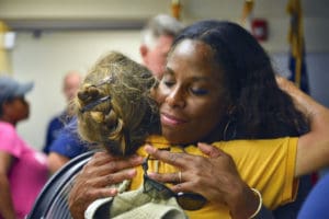 Delegate to Congress Stacey Plaskett embraces a Virgin Islander after the territory was hit by two category five hurricenes. (Photo from Plaskett's offical website)