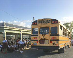 Students unload from a school bus at St. Croix Central High School in a 2017 file photo. (Source file photo)