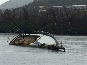 A sunken boat lies in the water off St. Thomas.