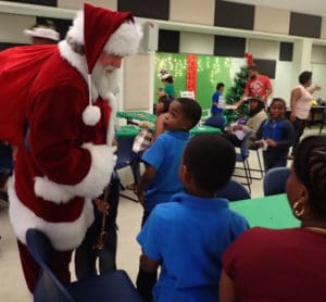 Santa talks to children about their Christmas decorations.