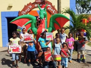 Youngsters at the Frederiksted Boys and Girls Club display their new board games. (Photo by Jessica Parker)