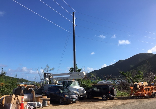 Workmen raise another composite pole on St. John. The new poles are replacing wooden poles that essentially haven't changed significantly in more than 100 years.