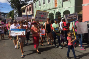 Women and men of all ages join to march through the streets of Christiansted for the Women's March.