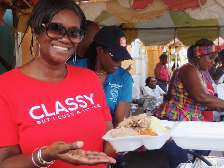 Karen Christian dishes up roast pork, gravy and sides at the Food, Arts and Crafts Fair.