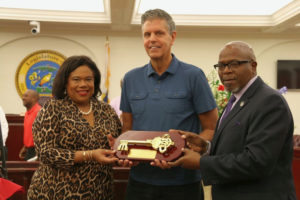 Paradise Jam founder Nels Hawkinson, center, receives the Key to the Territory from Tourism Commissioner Beverly Nicholson-Doty, and Senate President Myron Jackson.