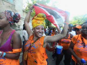 Members of the Splash J'ouvert troupe dance through the streets Wednesday morning.