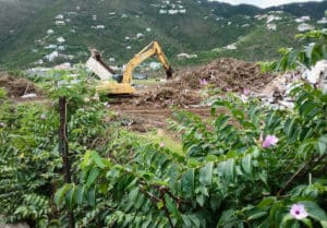 An earth mover sorts debris left by Hurricanes Irma and Maria on St. John. 