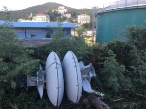 A tsunami warning siren, toppled by September's storms, lied in the bushes.