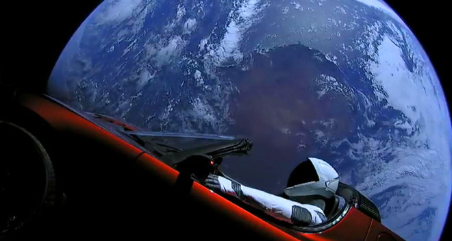 Elon Musk's cherry red Tesla convertible and a space-suited mannequin circle the Earth before heading out to deep space. (Photo from SPaceX)