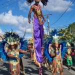 A stilt dancer towers over the parade