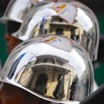 Reflections of the V.I. flag in the helmets