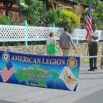 Marcelle Whitney and Doug Benton carry the American Legion banner
