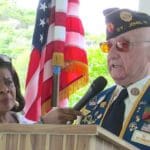 Jackie Clendenin holds the microphone