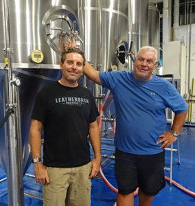 Aaron Hutchins and John Giannopoulos display some of the equipment that will soon be producing craft beer on St. Croix. (Anne Salafia photo)