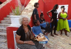 Elisa McKay,left, and Zuma Nisbett, also seated, enjoy the offerings at the fish fry, 