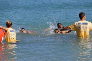 Volunteers help swimmers get through the first leg of the course.