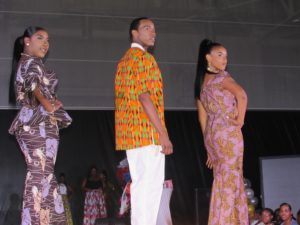 Three models displayed African inspired designs at a fashion show at UVI.