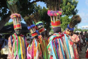 A dance troupe pauses after a lively performance that drew dozens of on lookers.