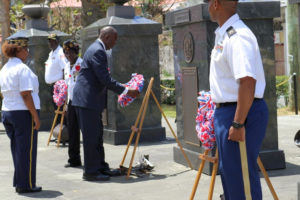 Lt. Gov. Osbert Potter helps lay memorial wreaths at the foot of each pillar commemorating the different branches of the armed forces.