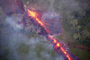 A fiery fissure from Kilauea oozes a thick paste of lava across the Hawaiian countryside. 