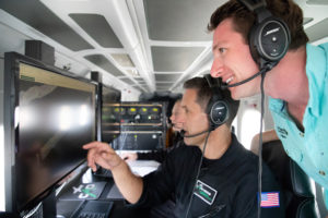 Greg Asner (left), founder of the Carnegie Airborne Observatory, and Joseph Pollock (right), coral strategy director for The Nature Conservancy, aboard the Carnegie Airborne Observatory. (Photo by Marjo Aho/TNC)