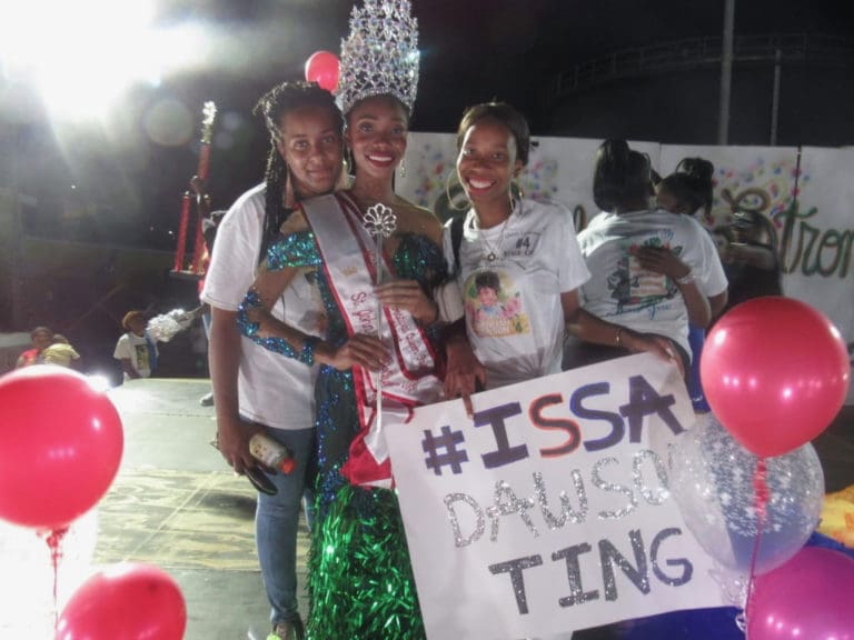 Newly crowned 2018 Miss St. John Festival Queen Chenijah Dawson with her mother and older sister.