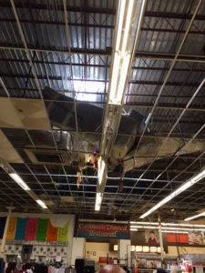 One of 18 air conditioning units that fell through the roof after Hurricane Irma dangles from the ceiling of the Tutu Park Kmart. (Photo by Brendda Burrows)